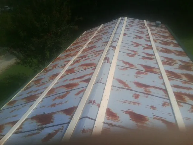 Rusted metal roof panels with new wood purlins before replacement — Storm Damage Roof Repair in Geyserville by Roofing Brothers