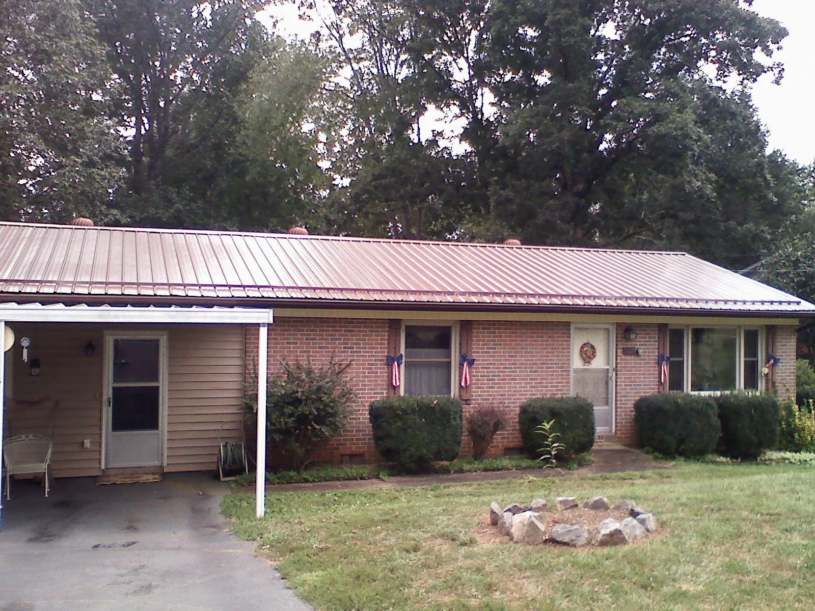 Bronze metal roof and carport on a brick ranch home — Roof Repair work by our crew in Geyserville